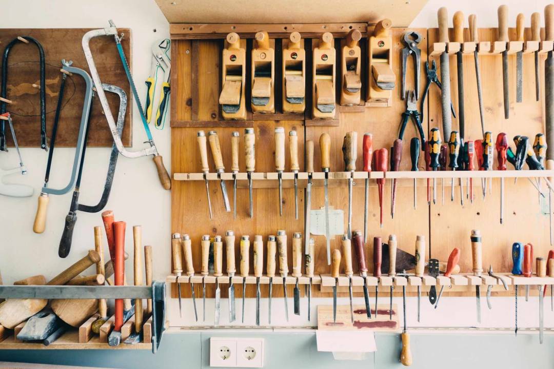 Assorted Tools Hanging From An Organised Tool Storage Board